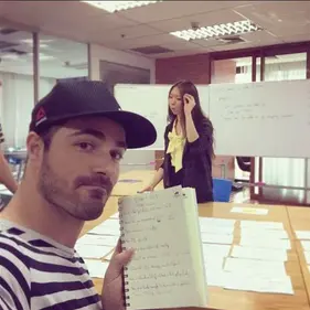 A student in class holding up his notebook